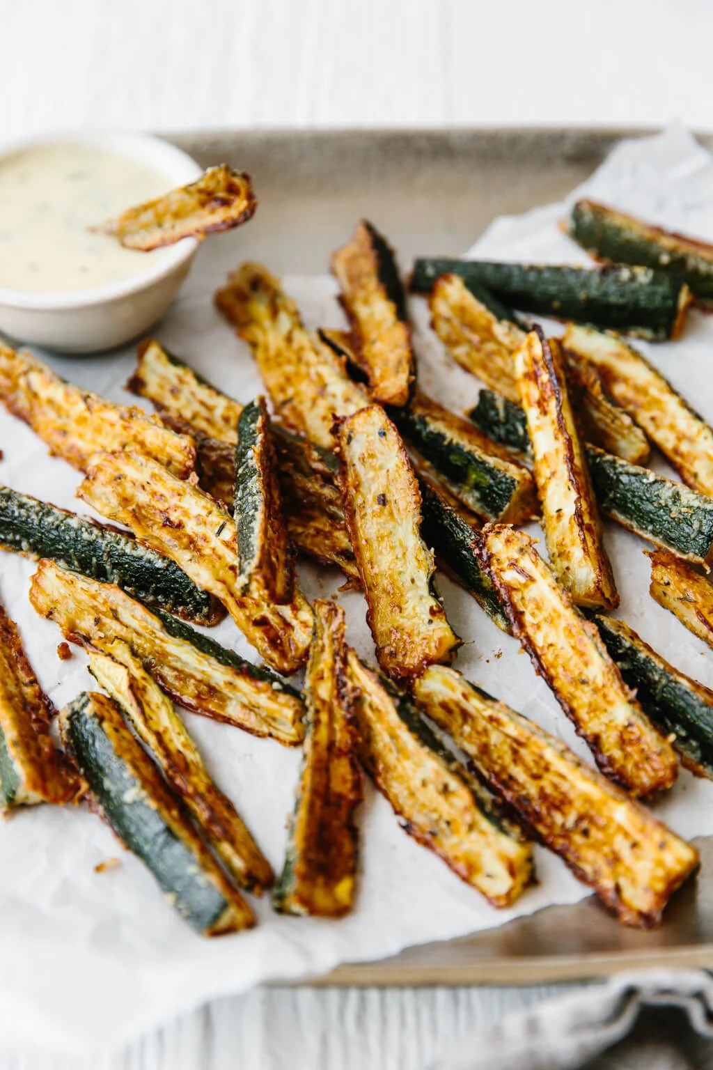 Baked zucchini fries on a platter. 